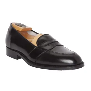 Alden Madisons 6845 Full Strap Loafer, crafted on the Aberdeen Last from Black Shell Cordovan, features a classic design with a low heel and smooth finish. A wooden shoe tree maintains its sleek, polished look from a three-quarter angle.