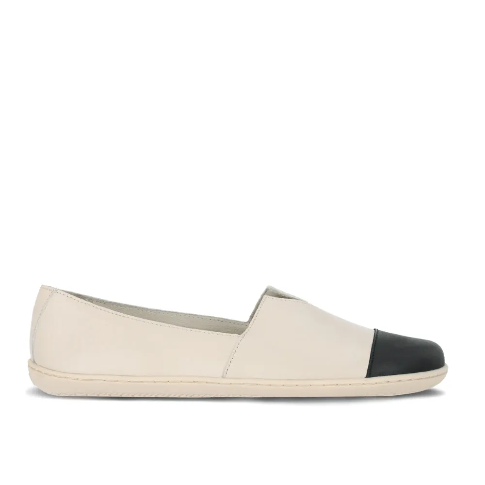 Light beige leather Be Lenka Rosaluna leather loafers with a v cut at the top of the foot, black leather toe caps, and light beige rubber soles. Right shoe is shown facing right against a white background. #color_light-beige
