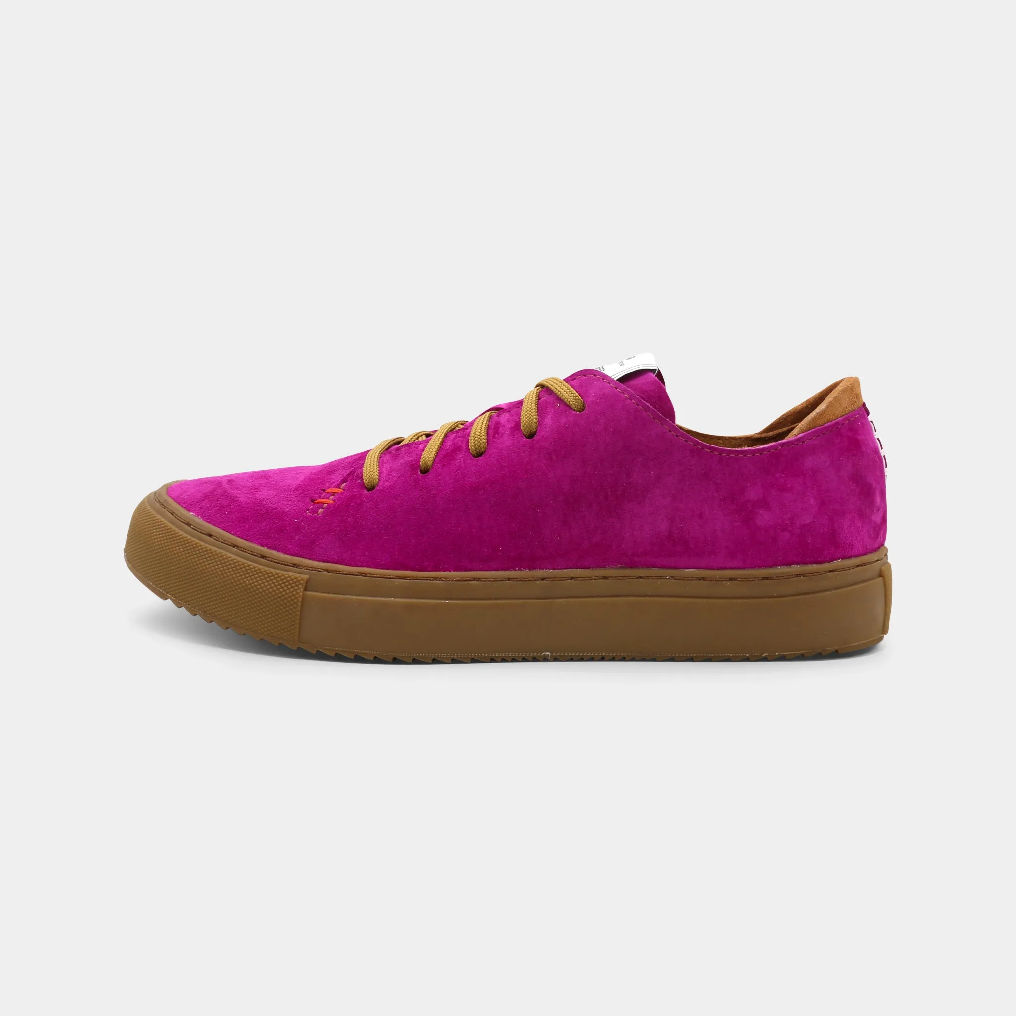A pink low-top sneaker with a brown sole and laces, lateral view.